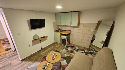 a room with a kitchen and a living room at Sunny Garden Old Town in Sarajevo