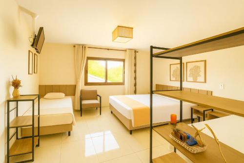 a hotel room with two beds and a desk at LSViver Hospedagem in Caxias do Sul