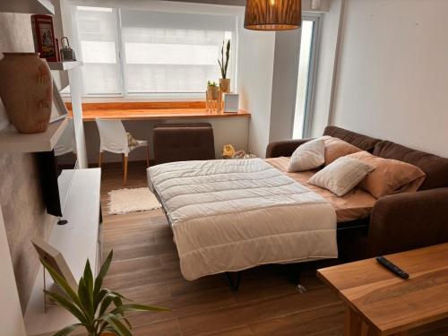 a living room with a bed and a couch at Pirca NQN in Neuquén