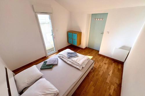 a living room with a couch and a window at Bright house with garden in Saint-Sébastien-sur-Loire