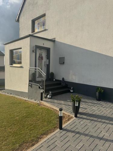 a house with two dogs sitting outside of it at Landliebe Osburg in Osburg