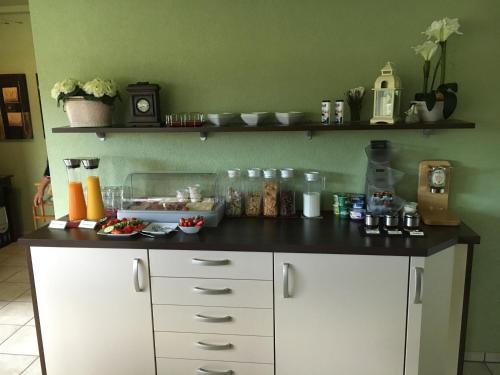a kitchen with a counter with food on it at Pension Villa Strandläufer in Norddeich