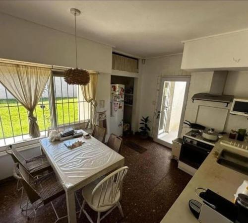 a kitchen with a table and chairs in a room at Chalet House in La Plata 