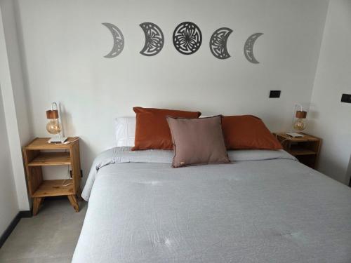 a bedroom with a bed with orange pillows on it at Sol del Atardecer in Rada Tilly