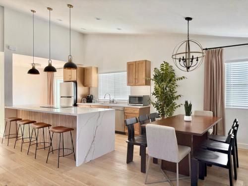 a kitchen and dining room with a table and chairs at Designer's Touch in San Diego