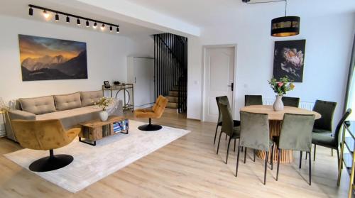 a living room with a couch and a table at Casa Runcu Dambovita in Bădeni