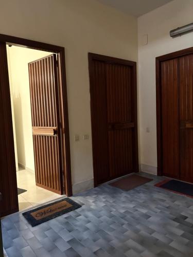 an empty room with two doors and a tile floor at Appartament house in Marcianise