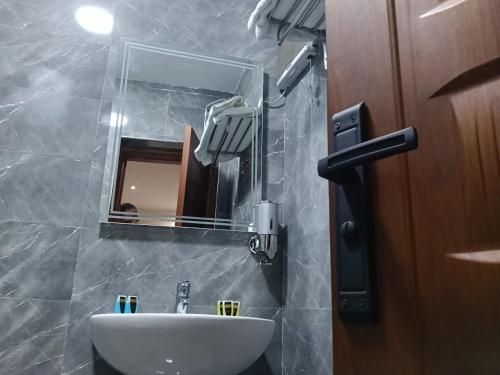 a bathroom with a sink and a mirror at Aurum Pyramids in Cairo