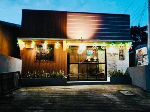 a building with christmas lights on the front of it at FYLL Homes - Francheska Suite Stylish 1-Bed Apartment with FREE parking in Cavinti Near Hulugan Falls in Cavinti