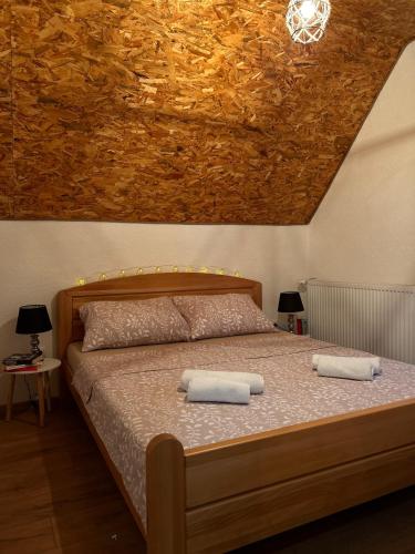a bedroom with a bed with two towels on it at Vikendica VIA - Čajuša, Kupres in Kupres
