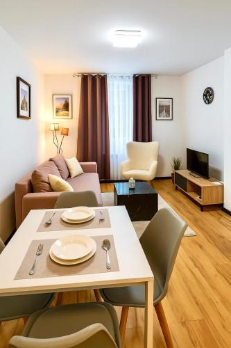 a living room with a couch and a table at Moderne Wohnung in Siegen in Siegen