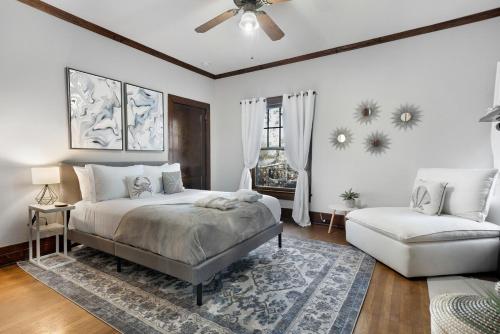 a bedroom with a bed and a couch and a fan at Southern Tides- Pool, Fire Pit & Games in Birmingham