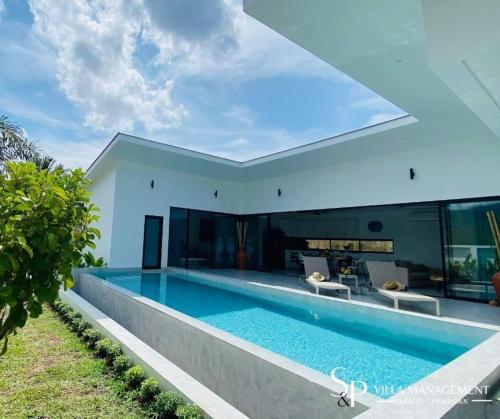 a swimming pool in the backyard of a house at Villa Noi By Sp Villa Management in Koh Samui 