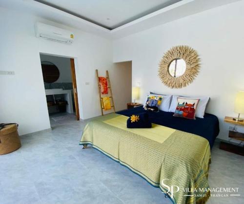 a bedroom with a bed and a mirror on the wall at Villa Noi By Sp Villa Management in Koh Samui 