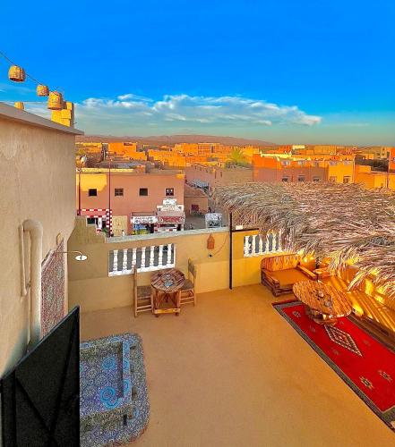 an apartment balcony with a view of a city at Riad Dar Sahara - Panoramic Rooftop & Outdoor Shower in Nkob
