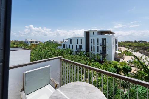 a balcony with a desk and a view of a building at Tropical apartments in The Soul 400m from Paje beach - Managed by KSN in Paje