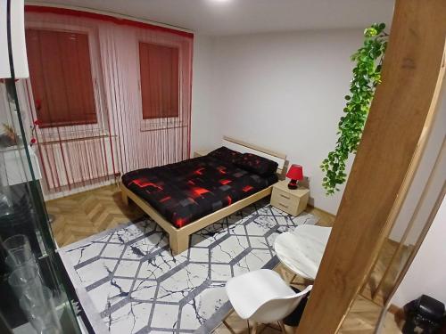 a room with a bed and a table and chairs at Stan na dan-Vasilije in Zvornik