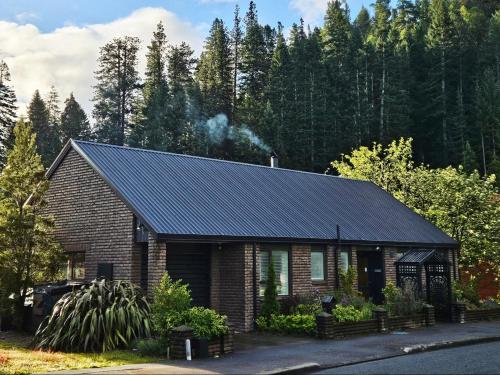 a brick house with a black roof at 27 Alpine Avenue in Hanmer Springs
