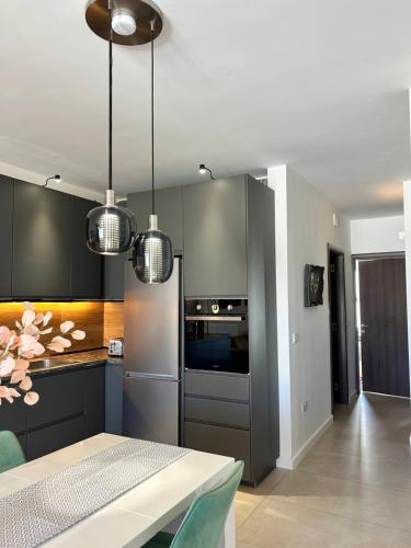 a kitchen with gray cabinets and a stove top oven at Luxury Private Suite & Room St Julians Central - Shared Apt in Is-Swieqi
