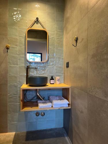 a bathroom with a sink and a mirror at Las Olas Miramar in Miramar