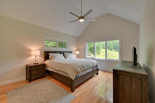 a bedroom with a bed and a ceiling fan at Ski In and Out! Black Mountain Resort Townhome in Jackson