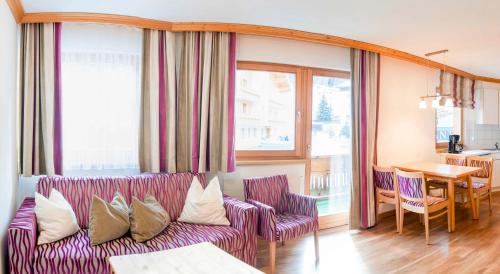 a living room with a couch and a table at Apartment Alouette in Samnaun