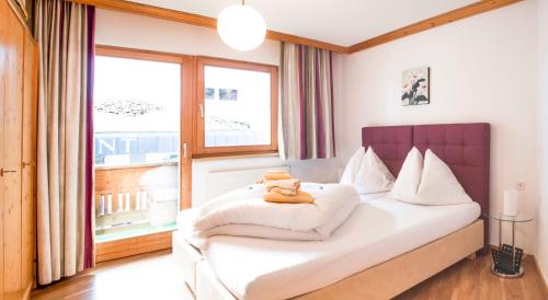 a bedroom with a bed with a teddy bear on it at Apartment Alouette in Samnaun