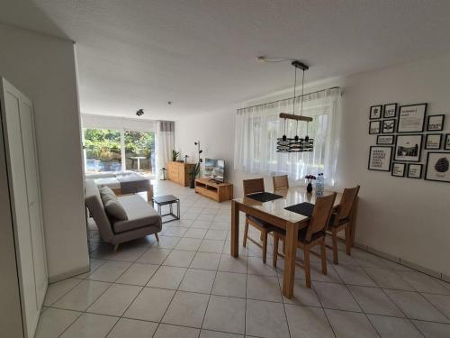 a living room with a table and chairs and a couch at Ferienwohnung Hirsch in Sinzheim