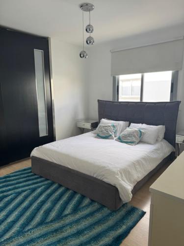 a bed with two pillows on it in a bedroom at Blue Tulip - Strovolos in Kato Lakatamia