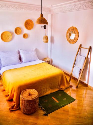 a bedroom with a bed and a chair in it at caban surf Tamraght in Tamraght Ouzdar