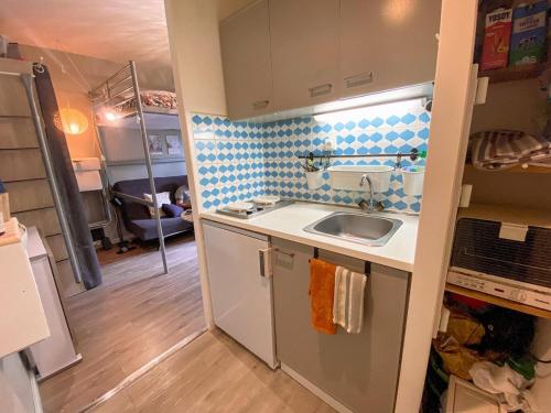 a small kitchen with a sink and a counter at Studio cosy proche départ station de ski in Porté-Puymorens