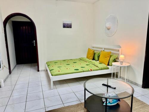a living room with a bed and a table at Maankhool Sleep 3 in Dubai