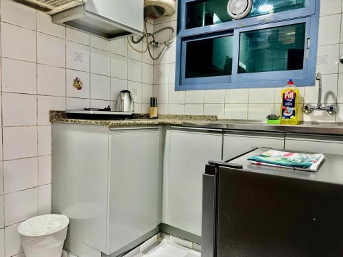 a small kitchen with a sink and a counter at Maankhool Sleep 3 in Dubai