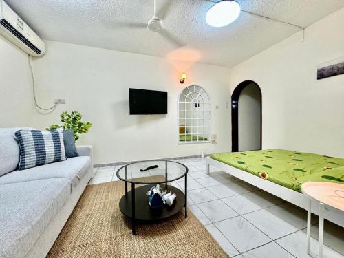 a living room with a couch and a table at Maankhool Sleep 3 in Dubai