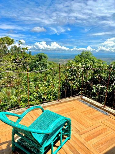 a blue chair sitting on top of a wooden deck at Casa Rosa - Paraíso na Natureza piscina natural, Wi-Fi - 25 minutos do centro in Brasília
