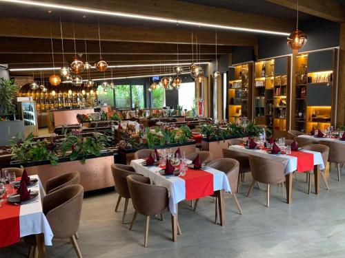 a dining room with tables and chairs and a restaurant at Golf Forest Creek Villas in Zavidovići