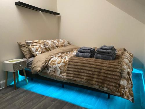 a bedroom with a bed with blankets and pillows at The Cottontail - Modern Private Room With Breakfast - Tamworth in Tamworth