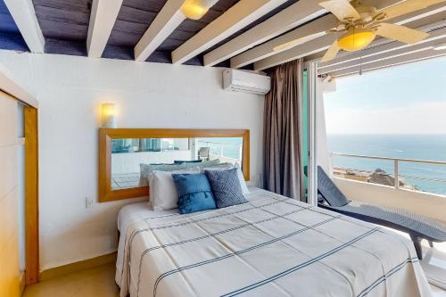 a bedroom with a bed with a view of the ocean at Torre Malibu, PH #902 in Puerto Vallarta