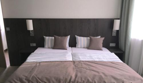 Postel nebo postele na pokoji v ubytování Hotel Concordia