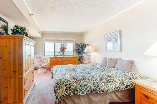 ein Schlafzimmer mit einem Bett, einer Kommode und einem Fenster in der Unterkunft Plaza 1404 in Ocean City