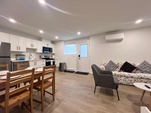 a kitchen and living room with a table and a couch at Kris Anclam in Langley