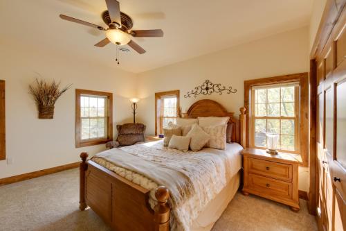 a bedroom with a bed and a ceiling fan at McJuggers Loft Walk to Lake, Park, Restaurants in Campbellsport
