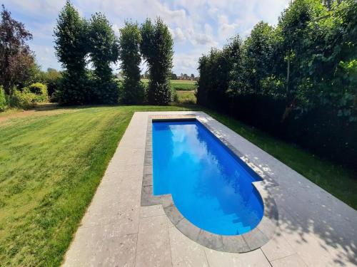 an overhead view of a swimming pool in a yard at Stylish Holiday Home in Zuidzande with Sauna in Zuidzande