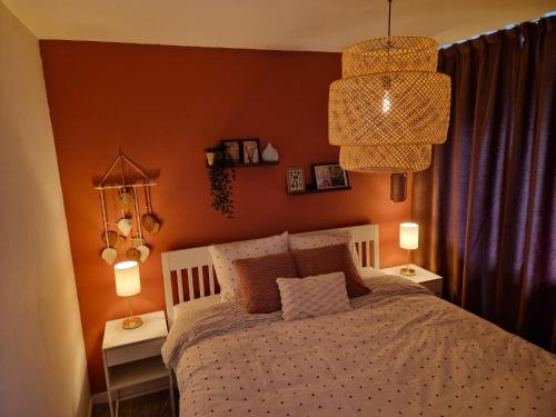 a bedroom with a bed and two tables with lamps at Kintsugi in Alphen aan den Rijn