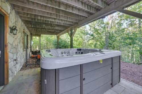a bath tub sitting on the outside of a house at Luxury Cabin in The Reserve at Boyne Mountain in Boyne Falls