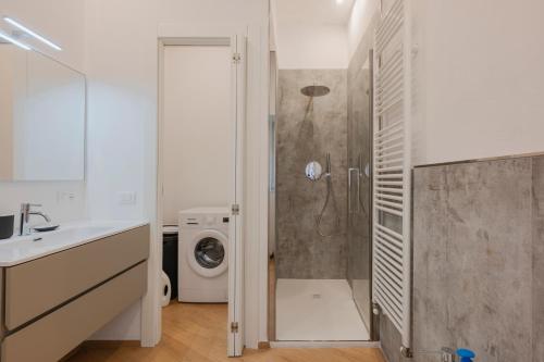 a bathroom with a shower and a washing machine at La Casa di Biancaneve in Recco