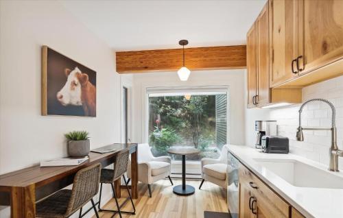 a kitchen with a sink and a table with chairs at Topnotch 329E in Stowe Fork