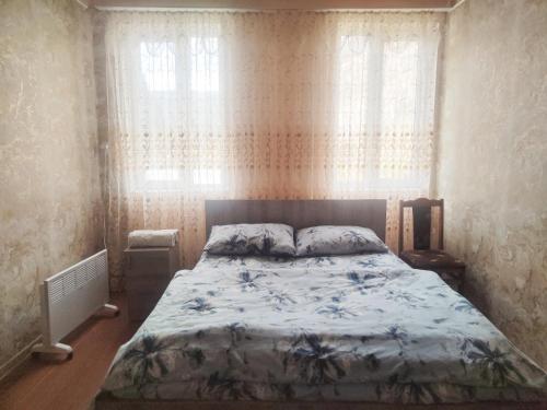 Una cama o camas en una habitación de Гостевой дом Туманян