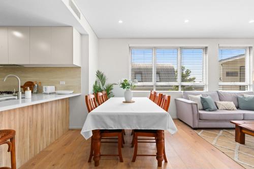 a kitchen and living room with a table and chairs at Seaside Retreat with Parking and Balcony in Newport