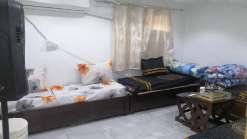 a room with a bed and a couch and a table at Constantine in Constantine